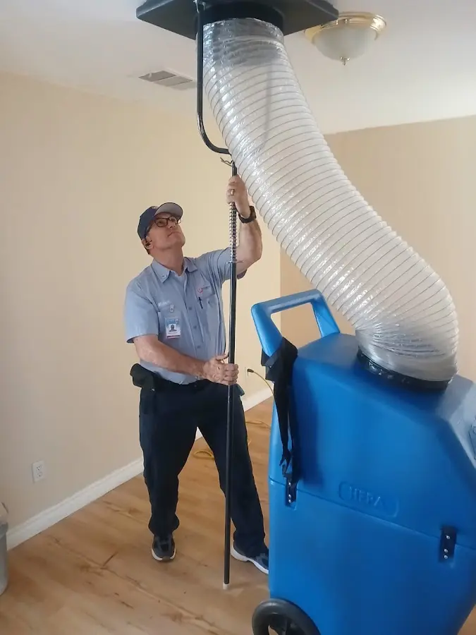 Furnace Tune-Up technician using HEPA equipment in Monroe